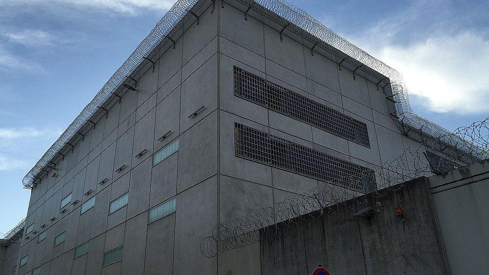 Gefängnisgebäude. Außenansicht mit Stachdraht.