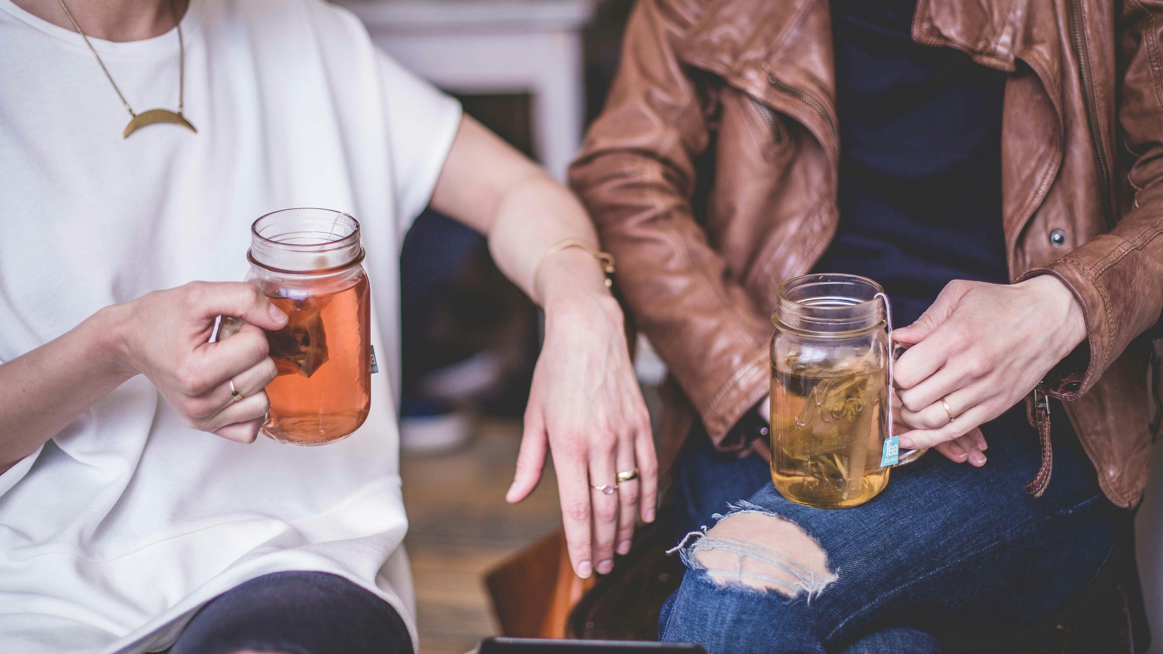 Bildausschnitt: zwei Menschen trinken Tee