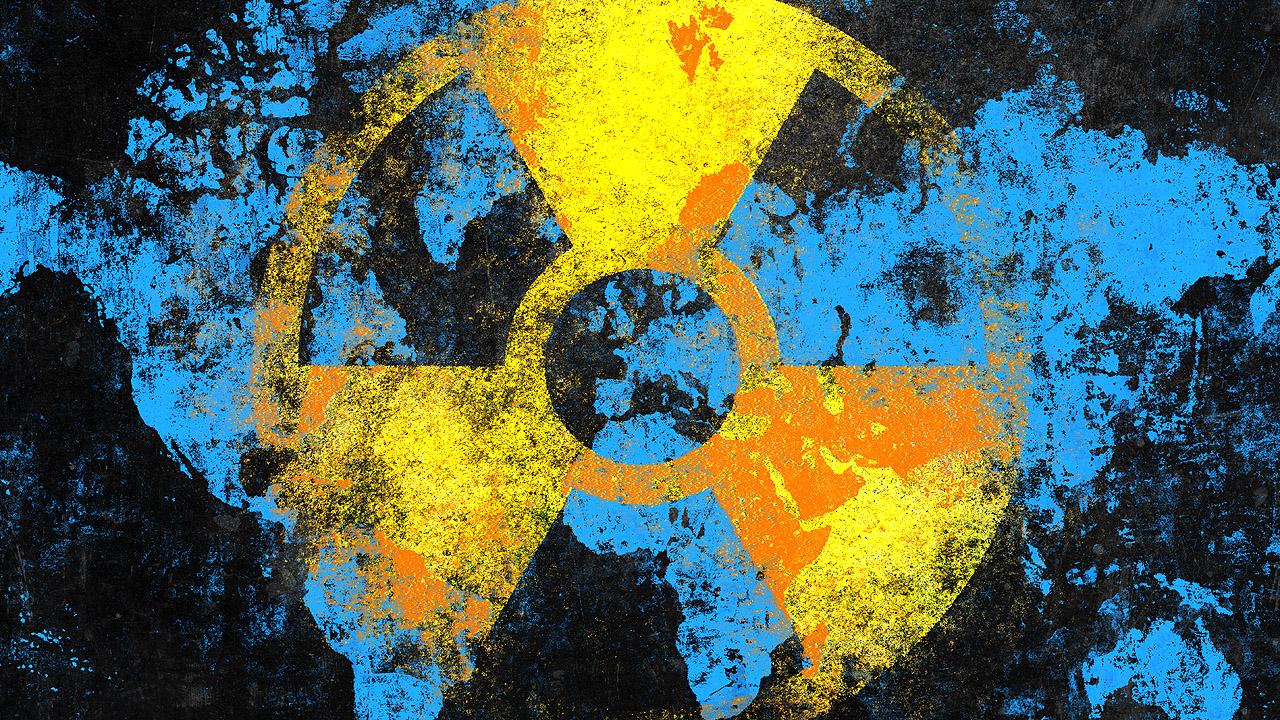Zeichen für Atomkraft über den Umrissen der Erde