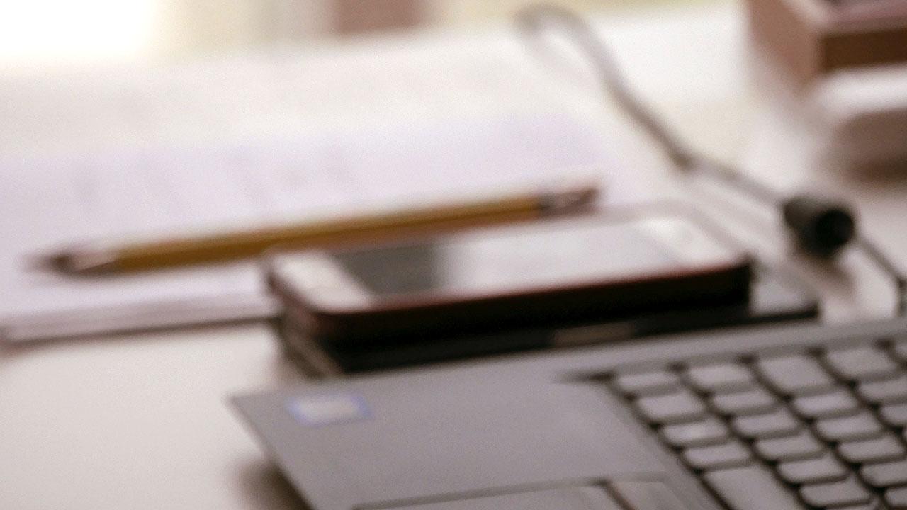 Laptop, Smartphone und Schreibblock