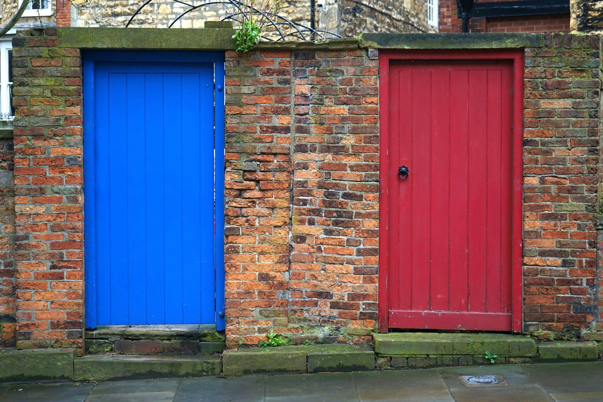 Mauer mit zwei Türen, eine blau, die andere in rot