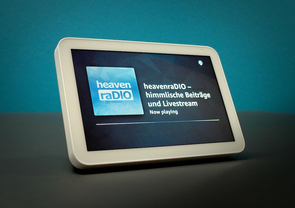 Die Grafik zeigt ein Alexa Echo Show Assistenz-System mit dem Logo von Heavenradio und dem Satz: Heavenradio - himmlische Beiträge und Livestream